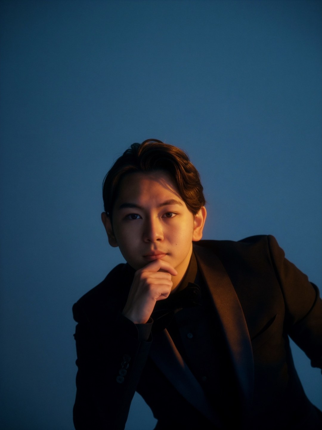 Portrait of Kendall Boom against a blue studio background